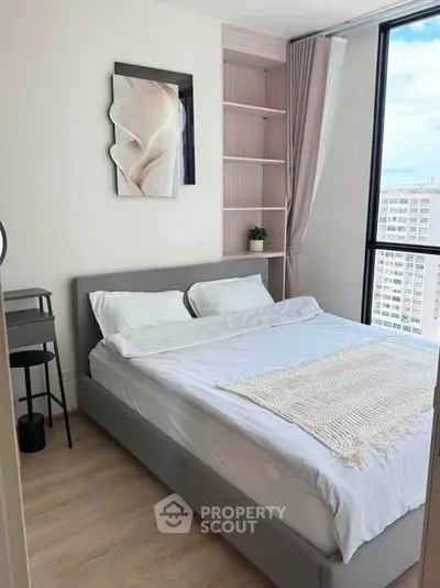 Modern bedroom with large window and stylish decor in urban apartment