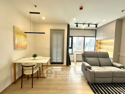 Modern living room with city view, cozy recliner, and stylish dining area.