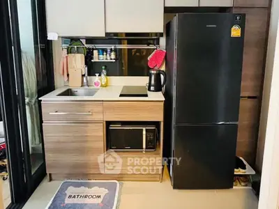 Compact kitchen with modern appliances and sleek cabinetry