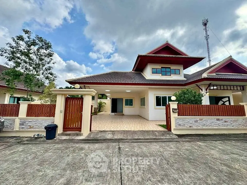 Charming suburban house with spacious driveway and traditional roof design