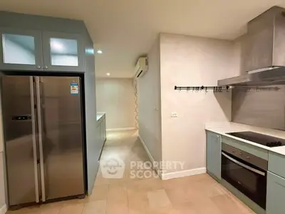 Modern kitchen with stainless steel appliances and sleek cabinetry in a spacious layout.
