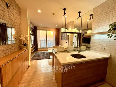 Modern open-layout living room with stylish kitchen and stunning city view.