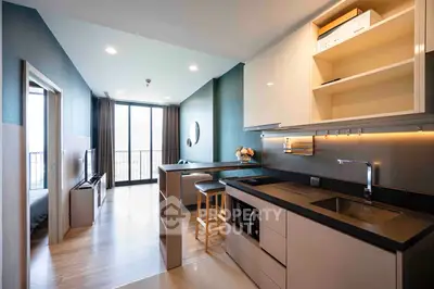 Modern open-layout kitchen and living area with sleek design and natural light