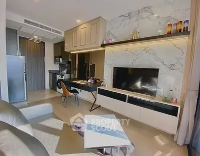 Modern living room with marble accent wall and sleek furniture in a stylish apartment.