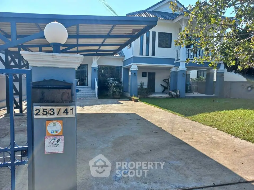 Charming two-story house with spacious driveway and lush front yard in a serene neighborhood.