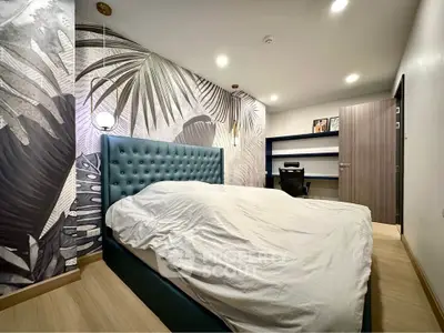 Modern bedroom with stylish wallpaper and cozy lighting, featuring a plush bed and functional workspace.
