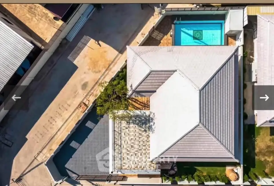 Aerial view of modern house with pool and spacious rooftop terrace.