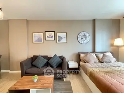 Modern studio apartment with cozy living area and stylish decor