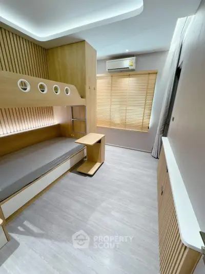 Modern bedroom with built-in bunk bed and sleek wooden design