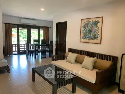 Spacious living room with modern furniture and large windows offering natural light.