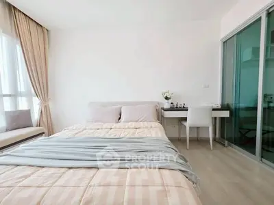 Bright and airy bedroom with modern decor and large window for natural light.