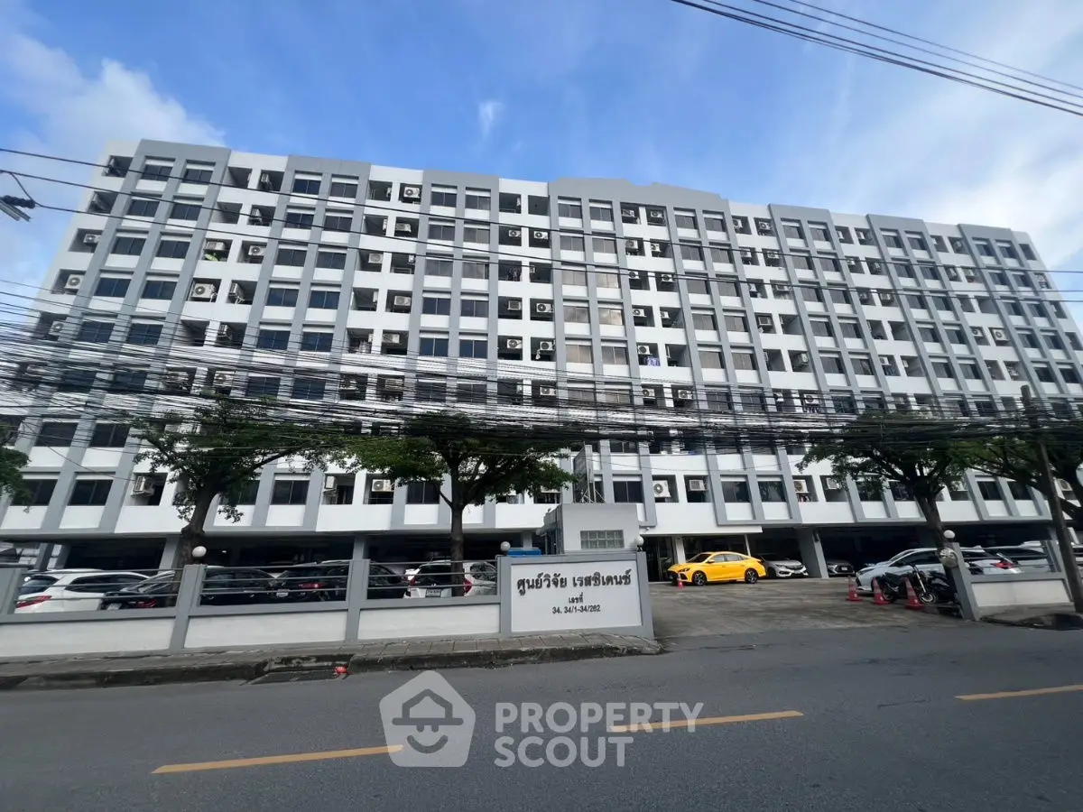 Modern multi-story building with parking and street view