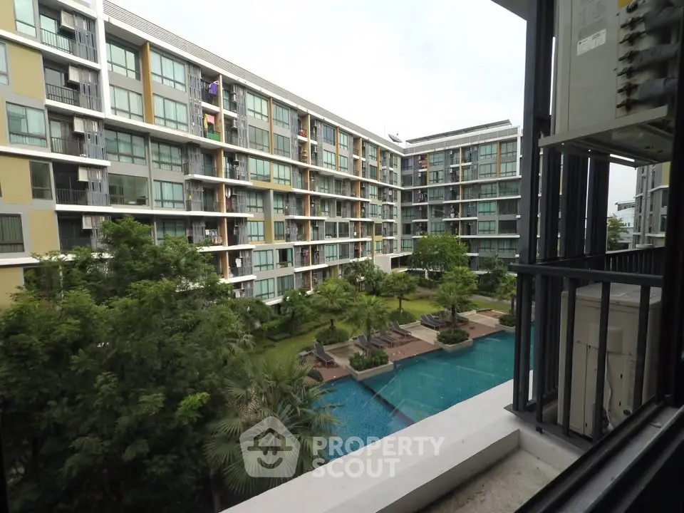 Modern condominium with pool view and lush greenery, perfect for urban living.