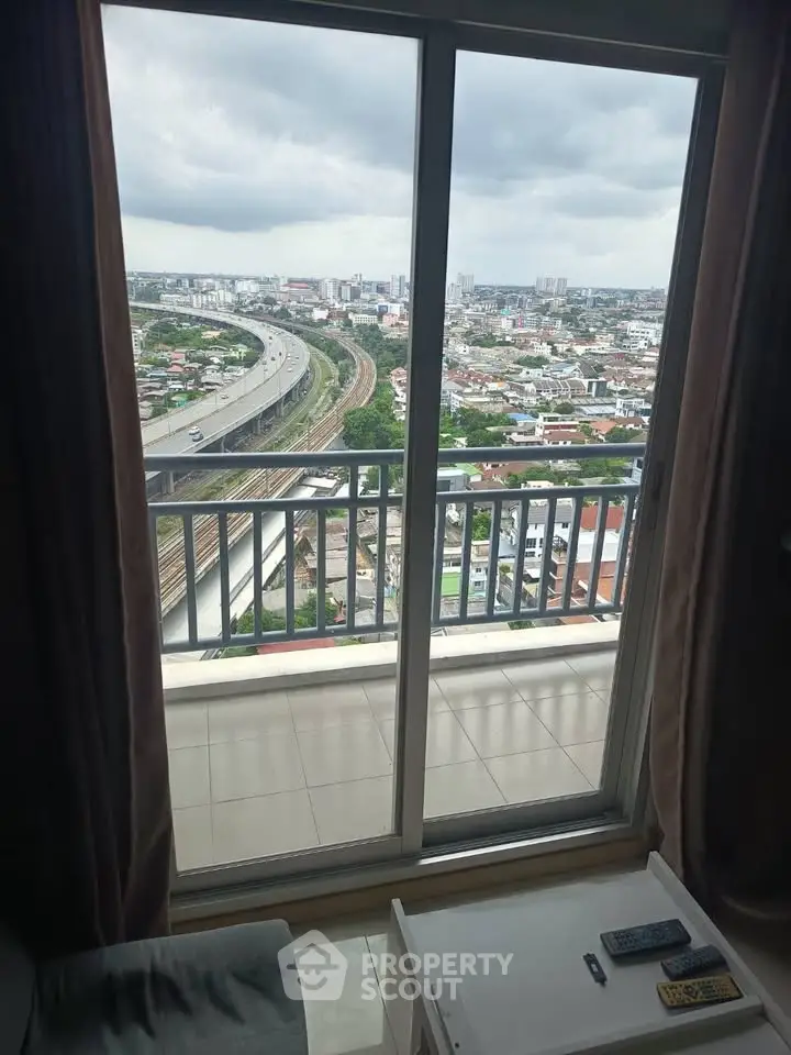 Stunning high-rise apartment with panoramic city view from the balcony, perfect for urban living.