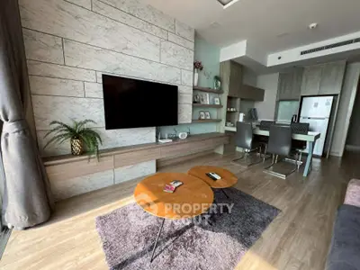 Modern living room with stylish decor and open kitchen layout in a contemporary apartment.