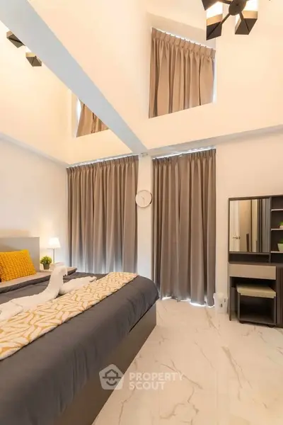 Luxurious bedroom with high ceilings and elegant decor