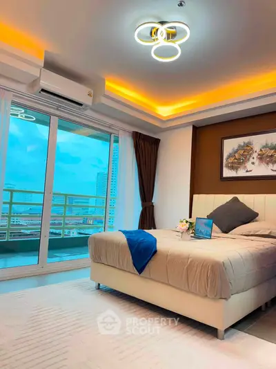 Luxurious bedroom with modern lighting and city view balcony in high-rise apartment.