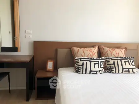 Modern bedroom with stylish decor and comfortable bedding in a cozy apartment.