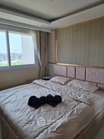 Luxurious bedroom with elegant decor and large window view