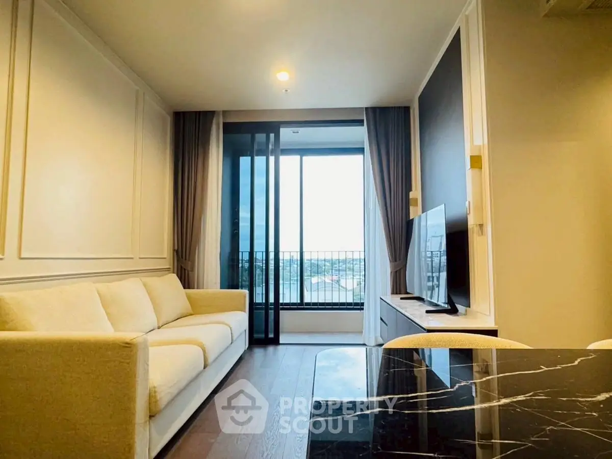 Modern living room with elegant sofa and large window offering a stunning view, perfect for relaxation.
