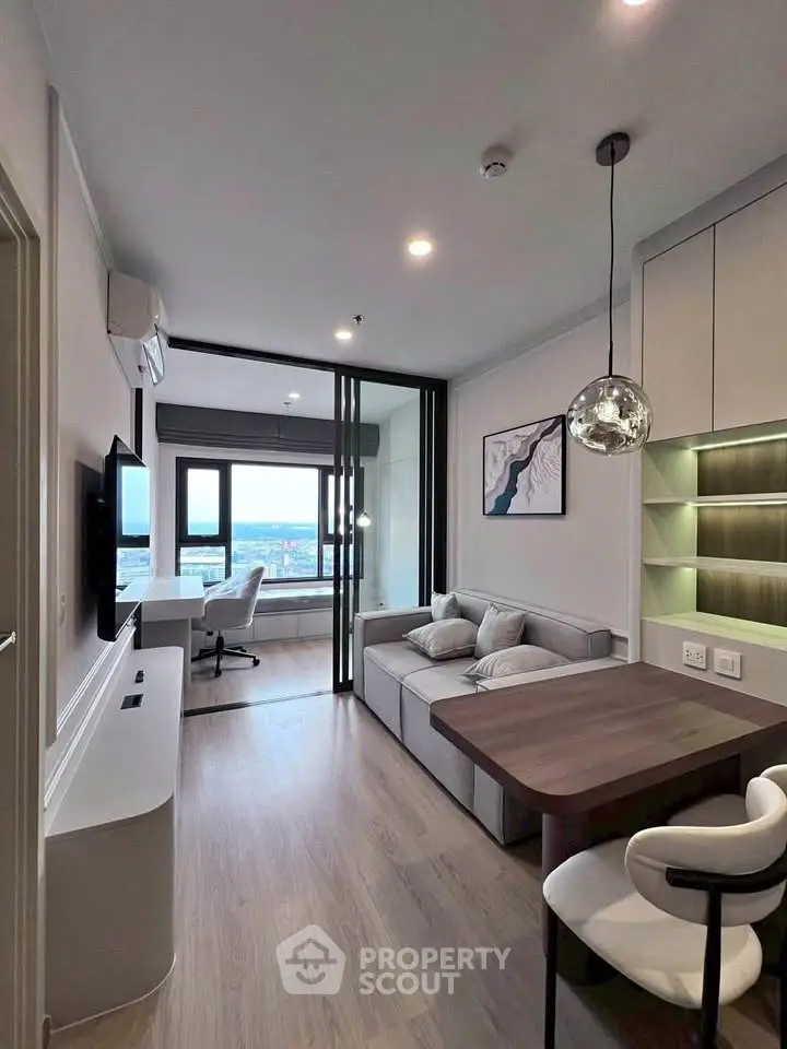 Modern living room with stylish decor and city view, featuring a cozy seating area and elegant lighting.