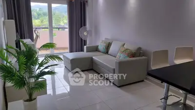 Modern living room with sleek sofa and balcony view, perfect for relaxation and comfort.