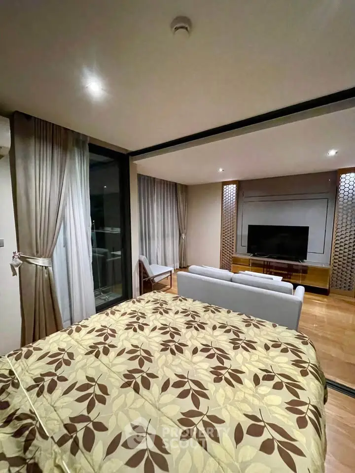 Modern studio apartment with stylish decor and large windows for natural light.