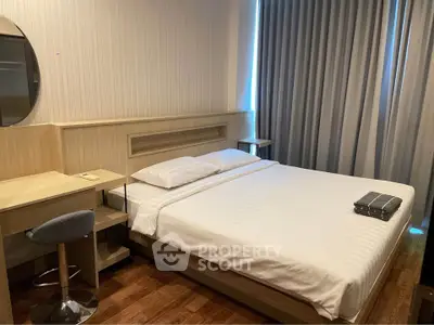 Modern bedroom with cozy bed and stylish decor in a contemporary apartment.