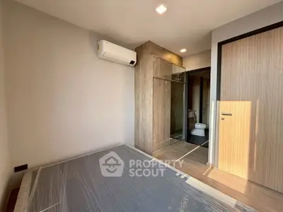 Modern bedroom with air conditioning and en-suite bathroom in a stylish apartment.