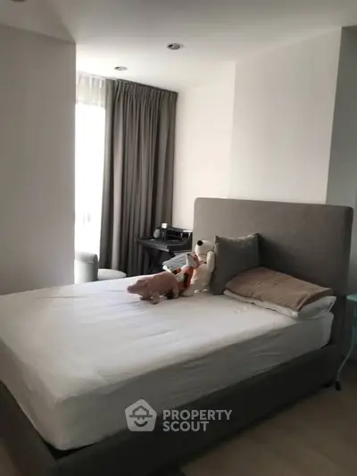 Cozy bedroom with plush bed and soft lighting, perfect for relaxation.