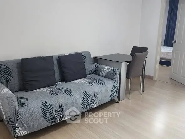 Cozy living room with stylish sofa and dining table, perfect for modern living.