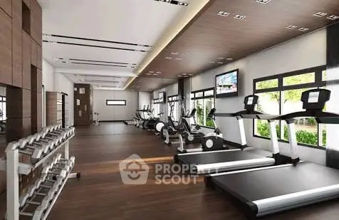Modern gym with treadmills and weights in luxury real estate property.