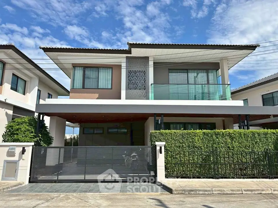 Modern two-story house with sleek design and spacious balcony, perfect for family living in a serene neighborhood.