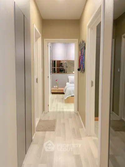 Modern hallway leading to a cozy bedroom with stylish decor