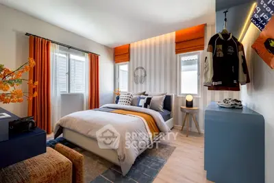Stylish modern bedroom with vibrant orange accents and cozy decor