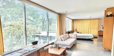 Spacious modern living room with large windows and natural light