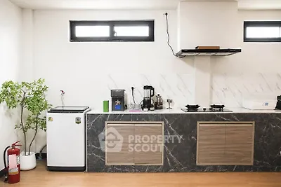 Modern kitchen with sleek countertops and appliances, featuring a gas stove and minimalist design.