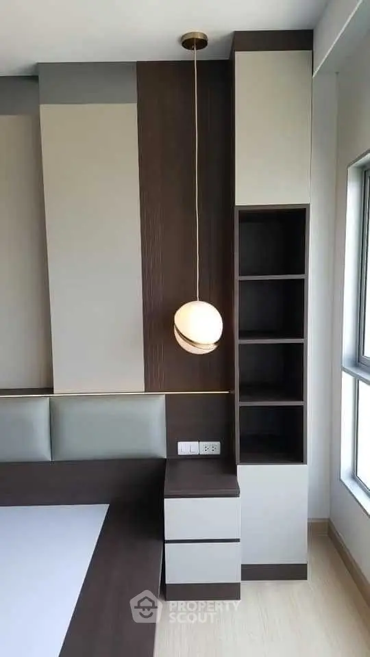Modern minimalist interior with sleek built-in furniture and stylish pendant light.