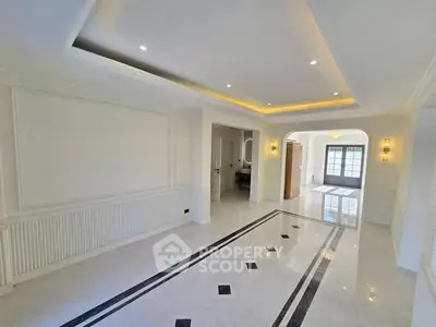 Spacious and elegant living room with modern lighting and marble flooring.
