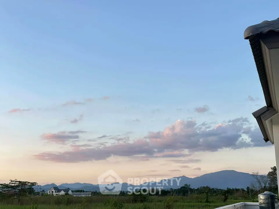 Stunning mountain view from a serene residential property at sunset.