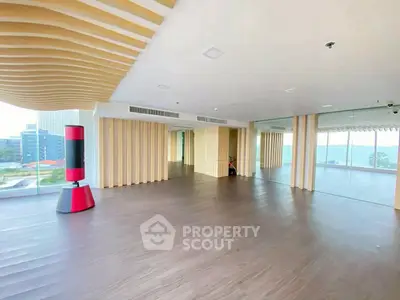 Spacious modern living room with panoramic windows and stylish ceiling design