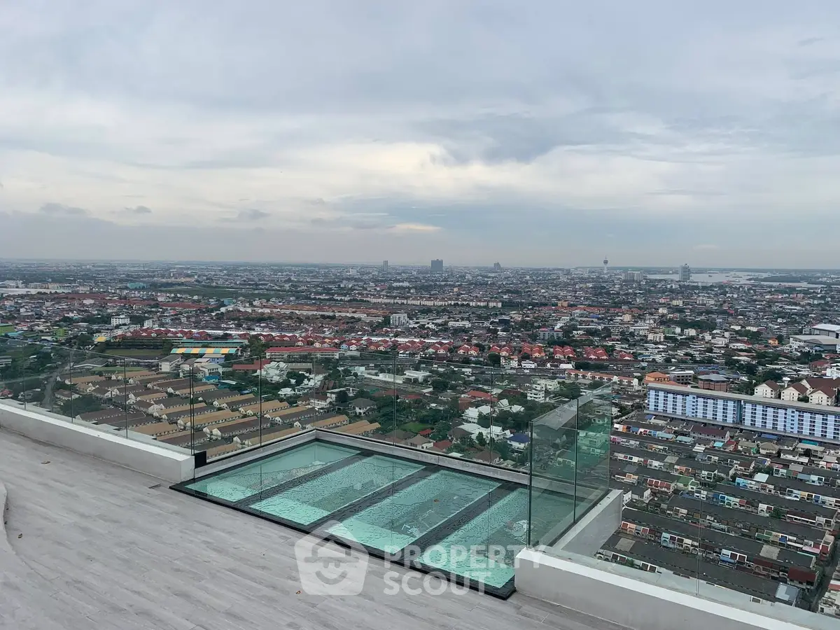 Stunning rooftop view with glass pool overlooking expansive cityscape