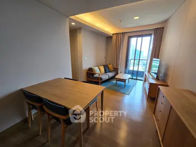 Modern living room with wooden furniture and city view balcony, perfect for urban living.
