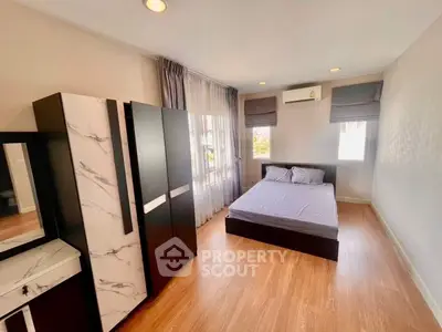 Spacious bedroom with modern furnishings and natural light