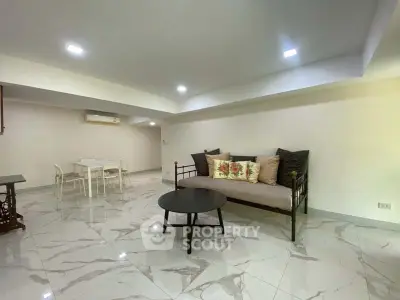 Spacious living room with modern decor and elegant marble flooring