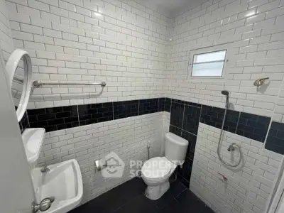 Modern bathroom with sleek white subway tiles and minimalist fixtures.