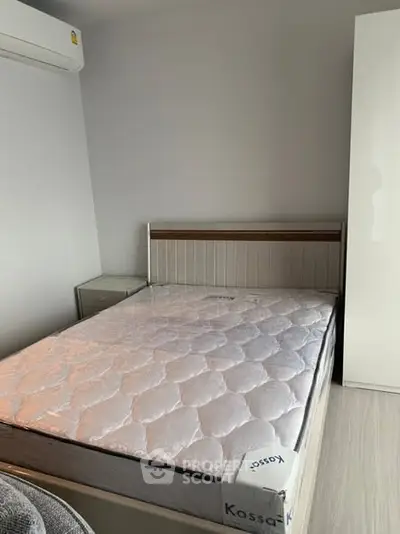 Cozy bedroom with modern furniture and air conditioning unit.