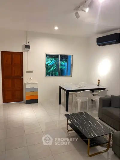 Modern living room with sleek furniture and air conditioning, perfect for cozy gatherings.