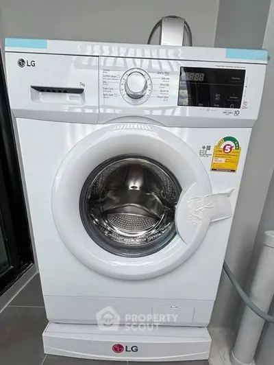 Modern LG washing machine in sleek laundry area, perfect for efficient home living.