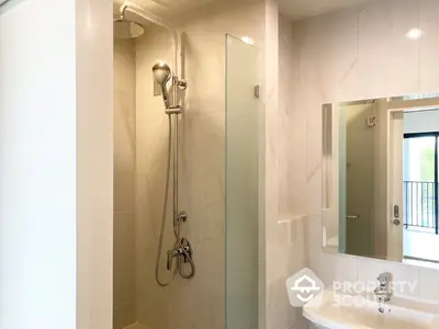 Modern bathroom with glass shower enclosure and sleek fixtures, offering a clean and minimalist design ideal for contemporary homes.